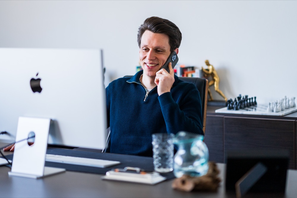 Philip Mettmann on a client call at his desk
